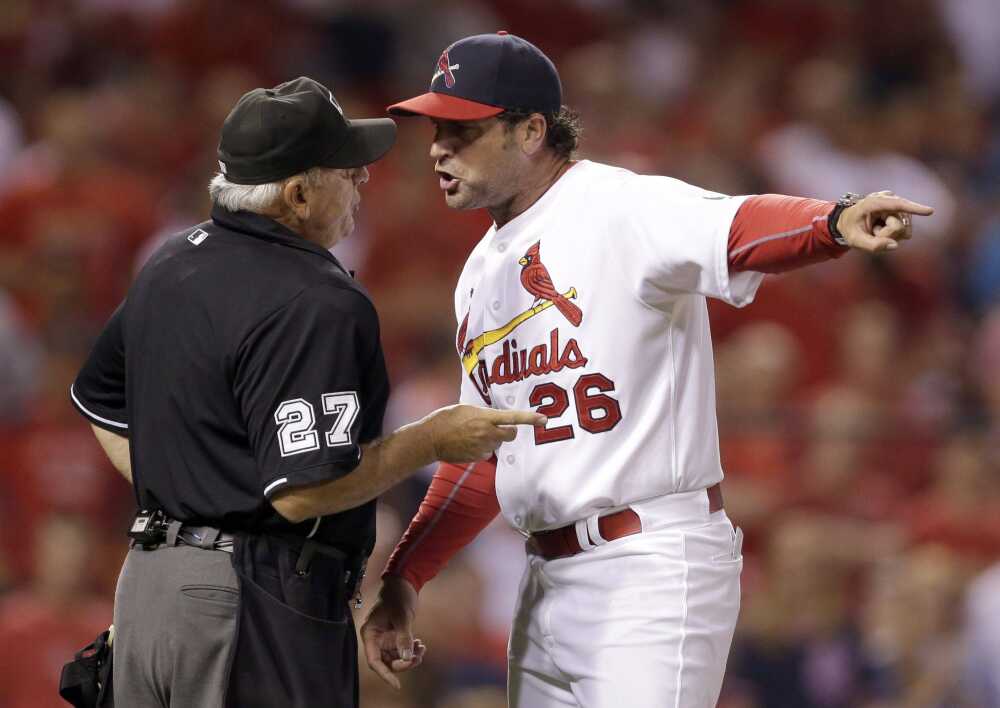 St. Louis Cardinals manager Mike Matheny throws batting practice