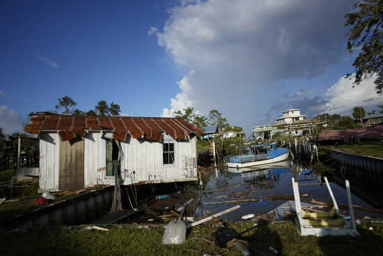 Residents pick through the rubble of lost homes and scattered belongings in  Hurricane Idalia's wake